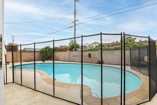 Private backyard pool with a safety fence